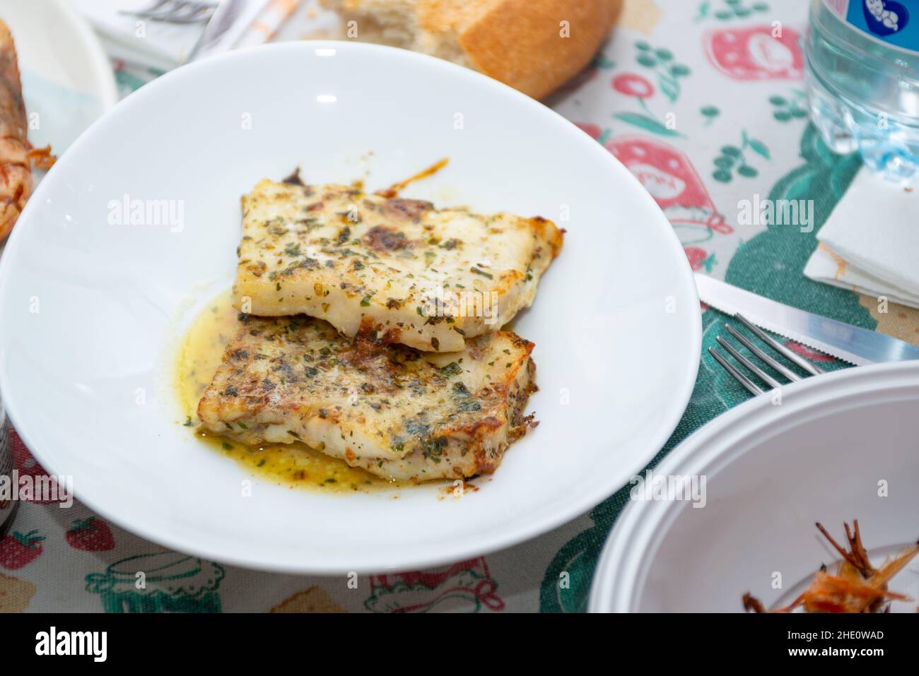 fried king prawns and cod fillet on plate closeup Stock Photo