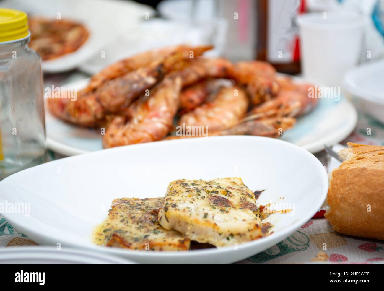 fried king prawns and cod fillet on plate closeup Stock Photo