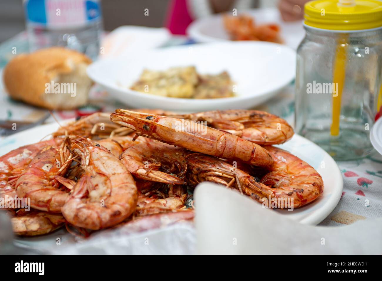 fried king prawns and cod fillet on plate closeup Stock Photo