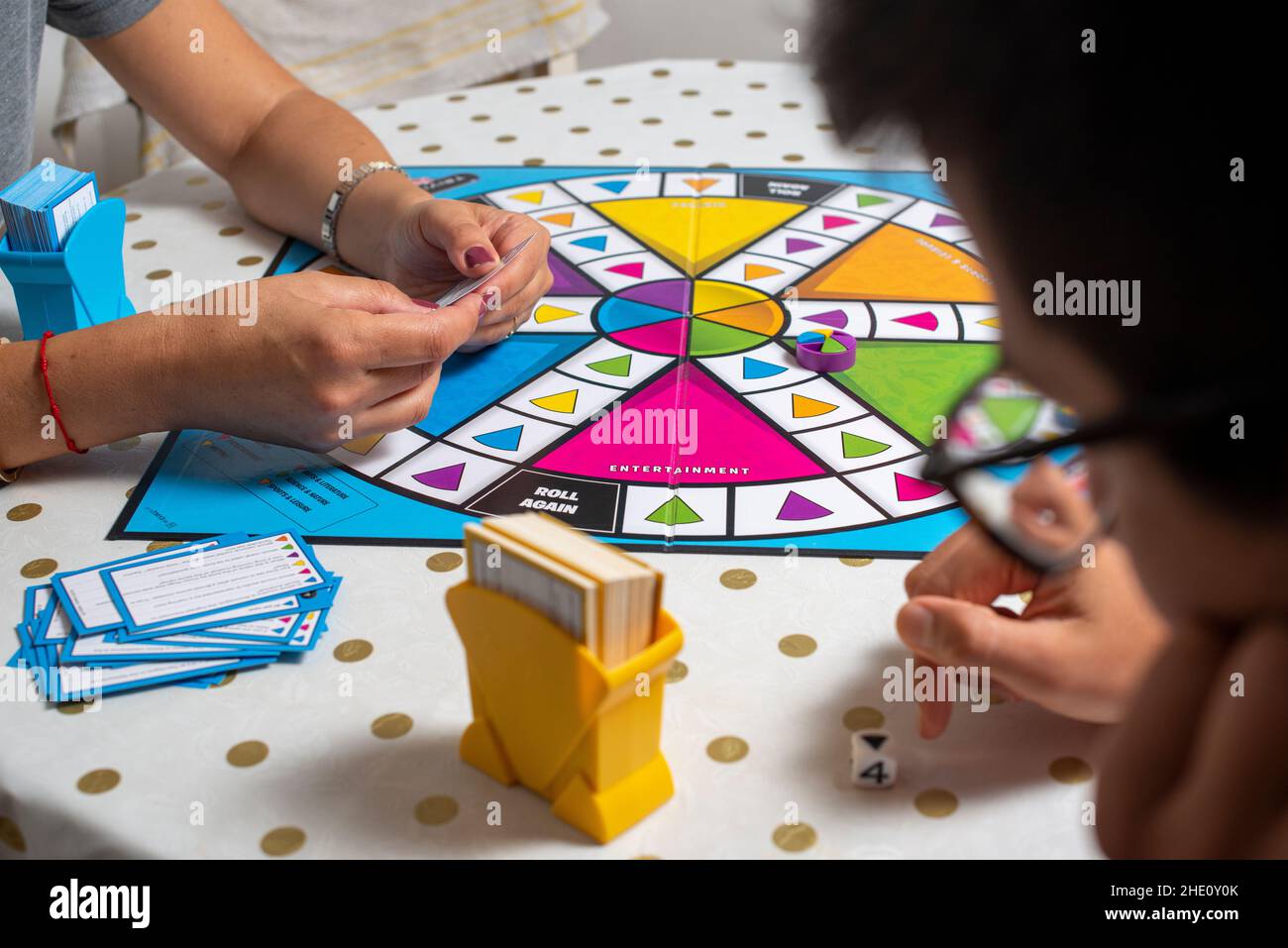 Playing Trivial  pursuit board game at home during Covid-19 lockdown, London,UK Stock Photo