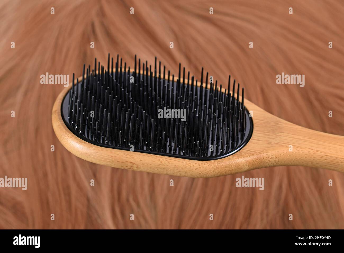 Detangler hair brush with different bristle lengths to separate hair instead of pulling it down Stock Photo