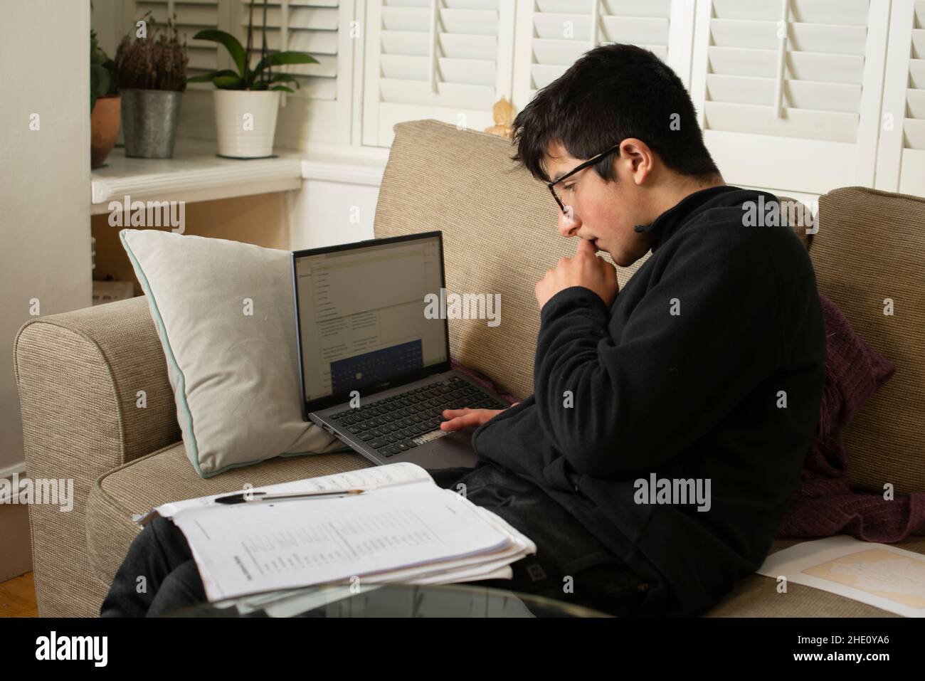 Schoolboy, year 9 , study at home . Remote learning during Covid-19 lockdown, Stock Photo