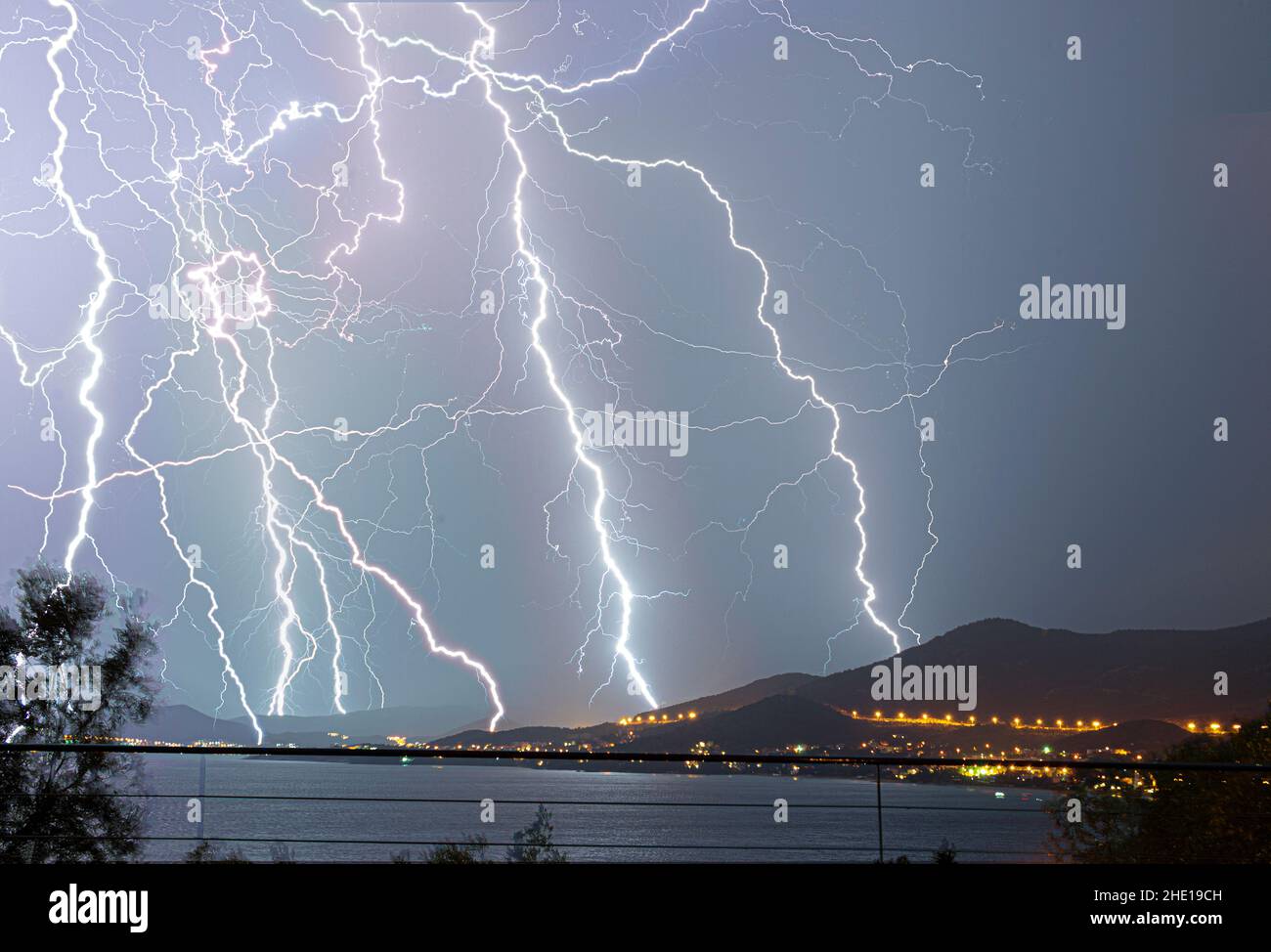 Mesmerizing view of Thunders. Electric storm over mountains and blue water Stock Photo