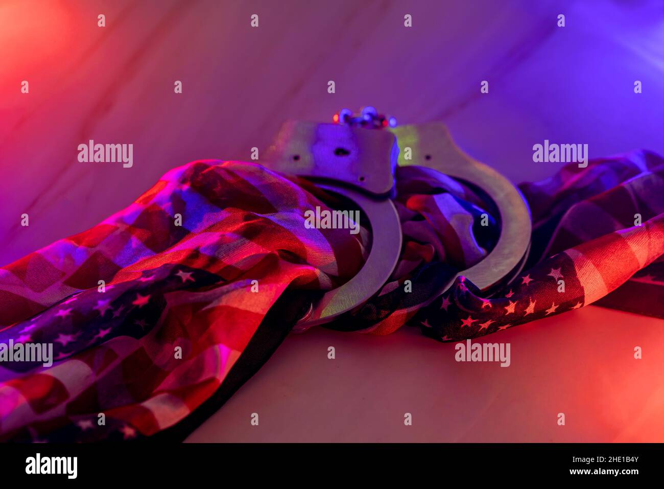 Police at under arrest of handcuffs police with the flashing red and ...