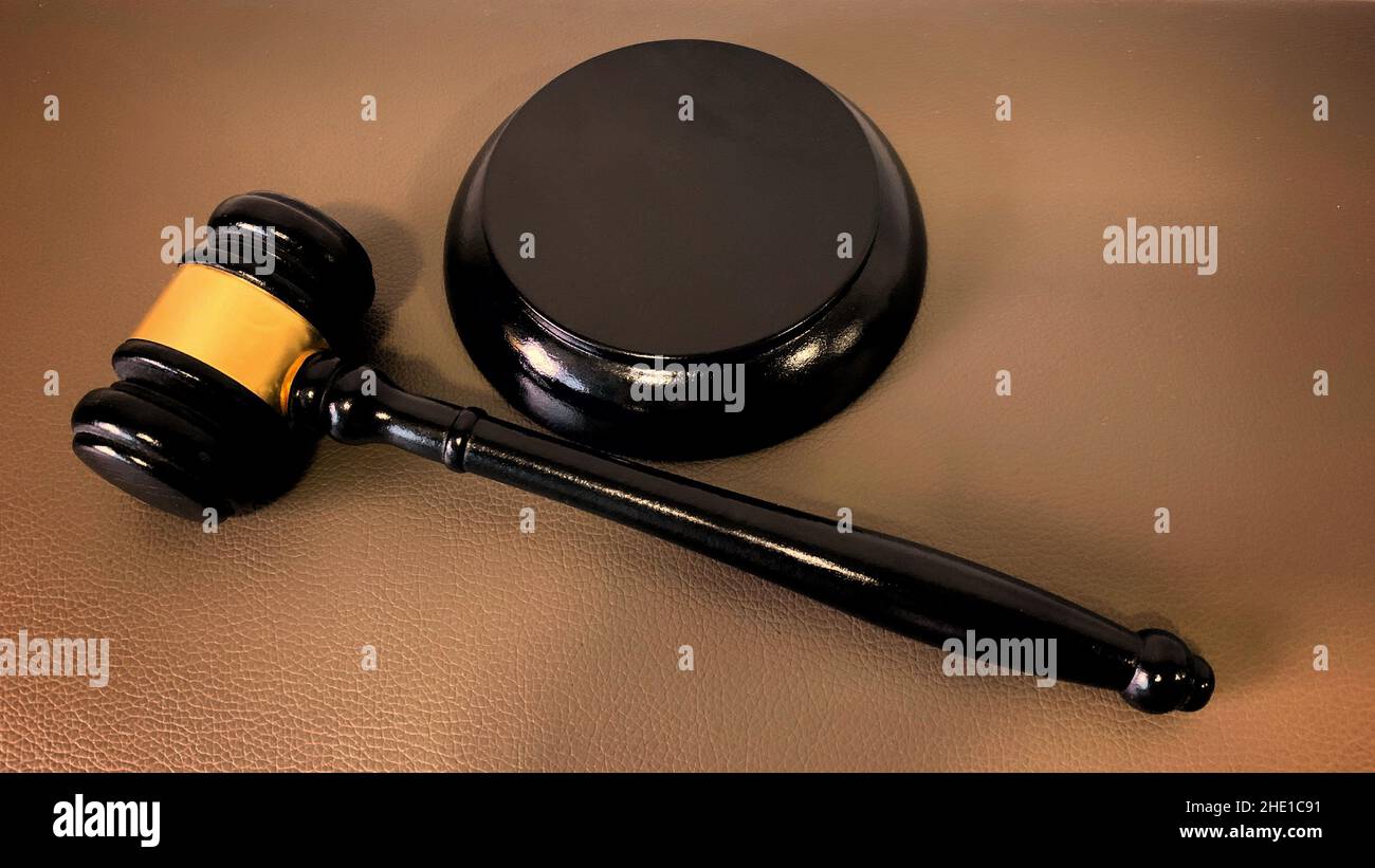 Close up of gavel hammer on brown background. Law concept. Stock Photo