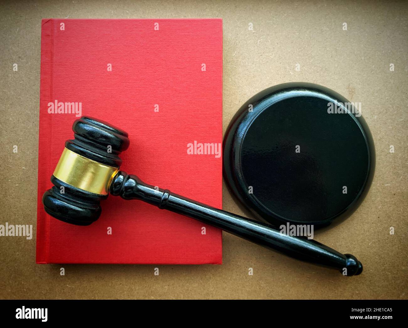 Close up of gavel hammer on top of red cover book. Law concept. Stock Photo