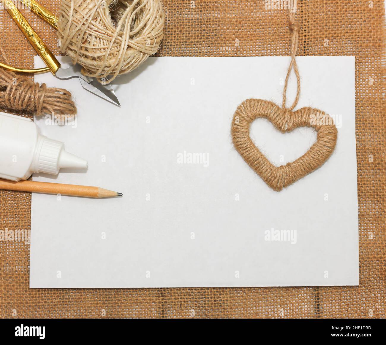 Making a jute heart for decorative design. Happy valentine's day background. People lifestyle concept. Romantic background Stock Photo
