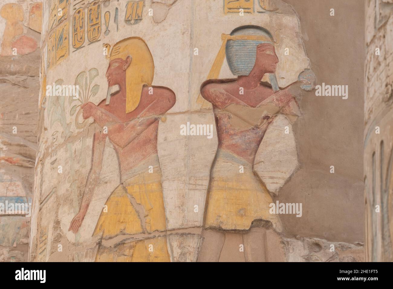 Ancient egyptian relief sculptures that have remained well preserved and painted on the columns in the Hypostyle hall in Karnak, Egypt. Stock Photo