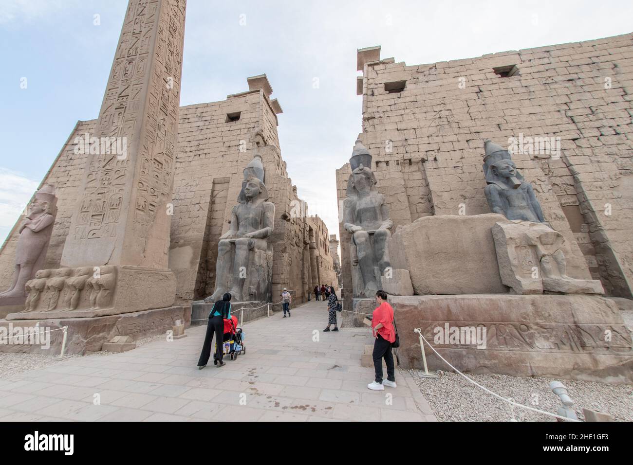 The entrance to Luxor temple, flanked by seated statues of King Ramses ...