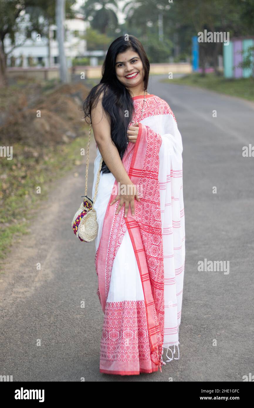 A pretty Indian woman in red saree and long hair posing for camera on road Stock Photo - Alamy A pretty Indian woman in red saree and long hair posing for camera on road Stock Photo - Alamy