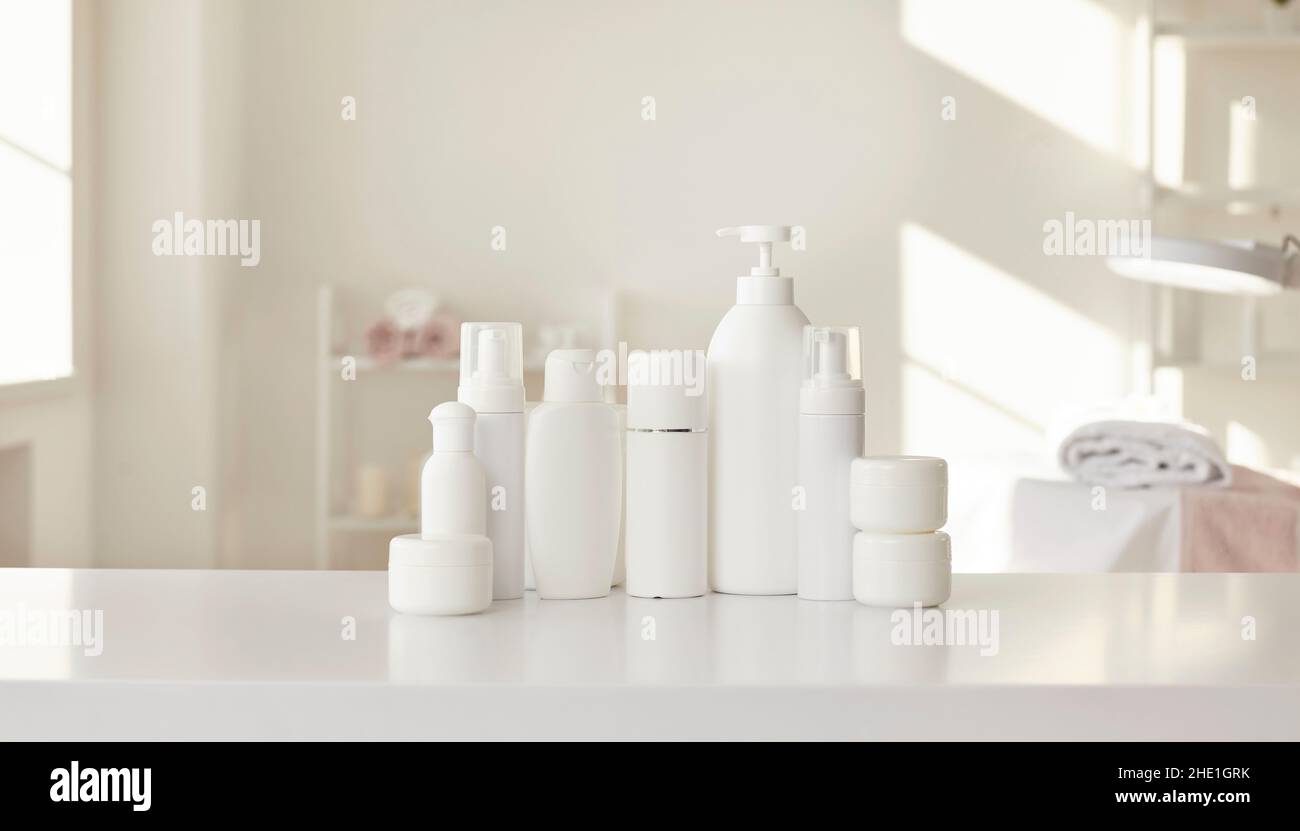 White mockup bottles and jars with professional skin care products in