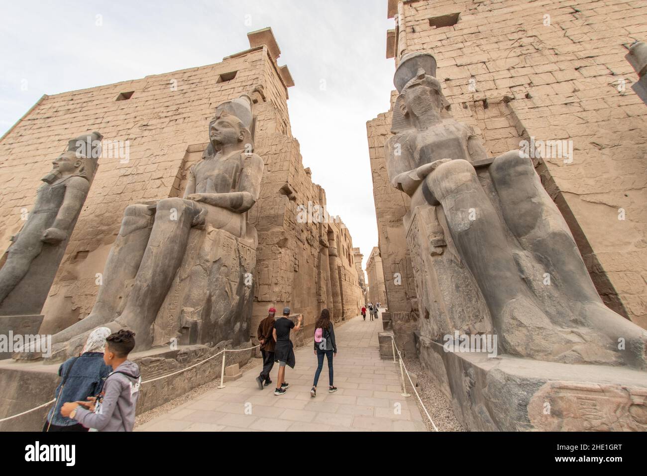 The entrance to Luxor temple, flanked by seated statues of King Ramses ...