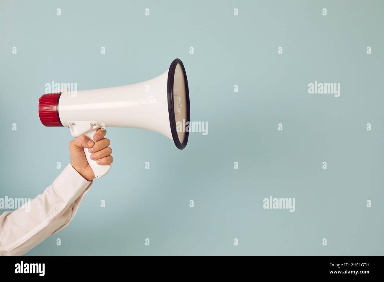 Man hand with loudspeaker make announcement Stock Photo
