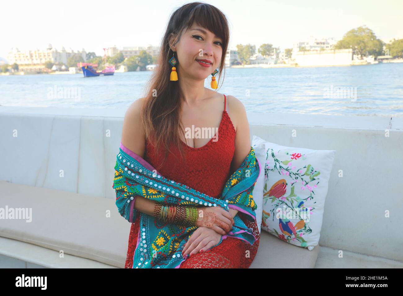 Pretty Thai woman sitting on the bank of the river, healthy life concept Stock Photo