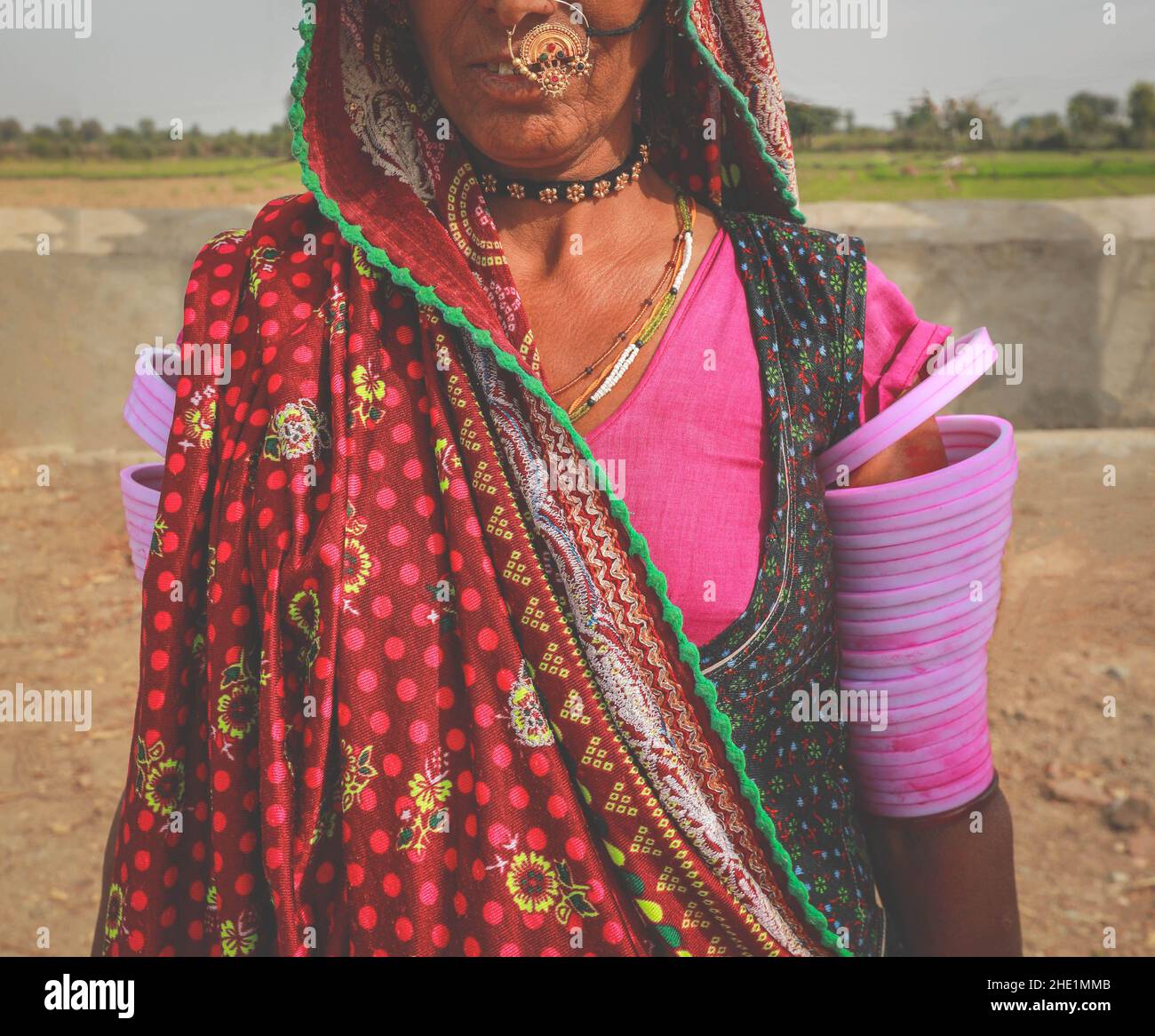 Helf face of Indian Rajasthani woman wearing traditional colourful clothing and jewellery Stock Photo