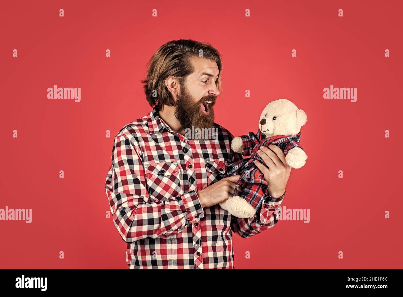 Bearded and stylish. happy valentines day. surprised bearded man hold teddy bear. male feel playful with bear. brutal mature hipster man play with toy Stock Photo