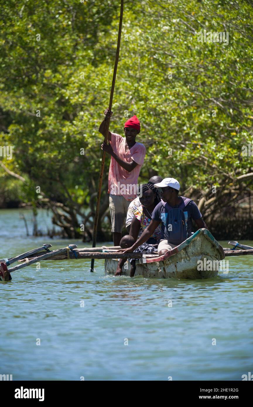 Tourists in a wooden dugout canoe travelling along the Kongo river, Kenya, East Africa Stock Photo