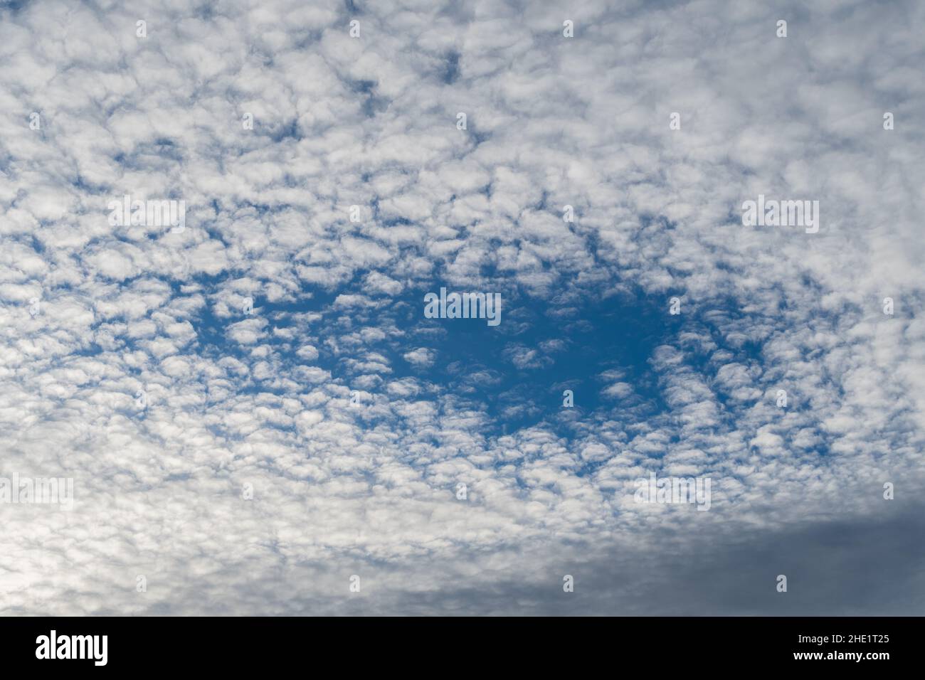 Vaduz, Liechtenstein, December 23, 2021 Blue hole within a cloud layer in the sky Stock Photo