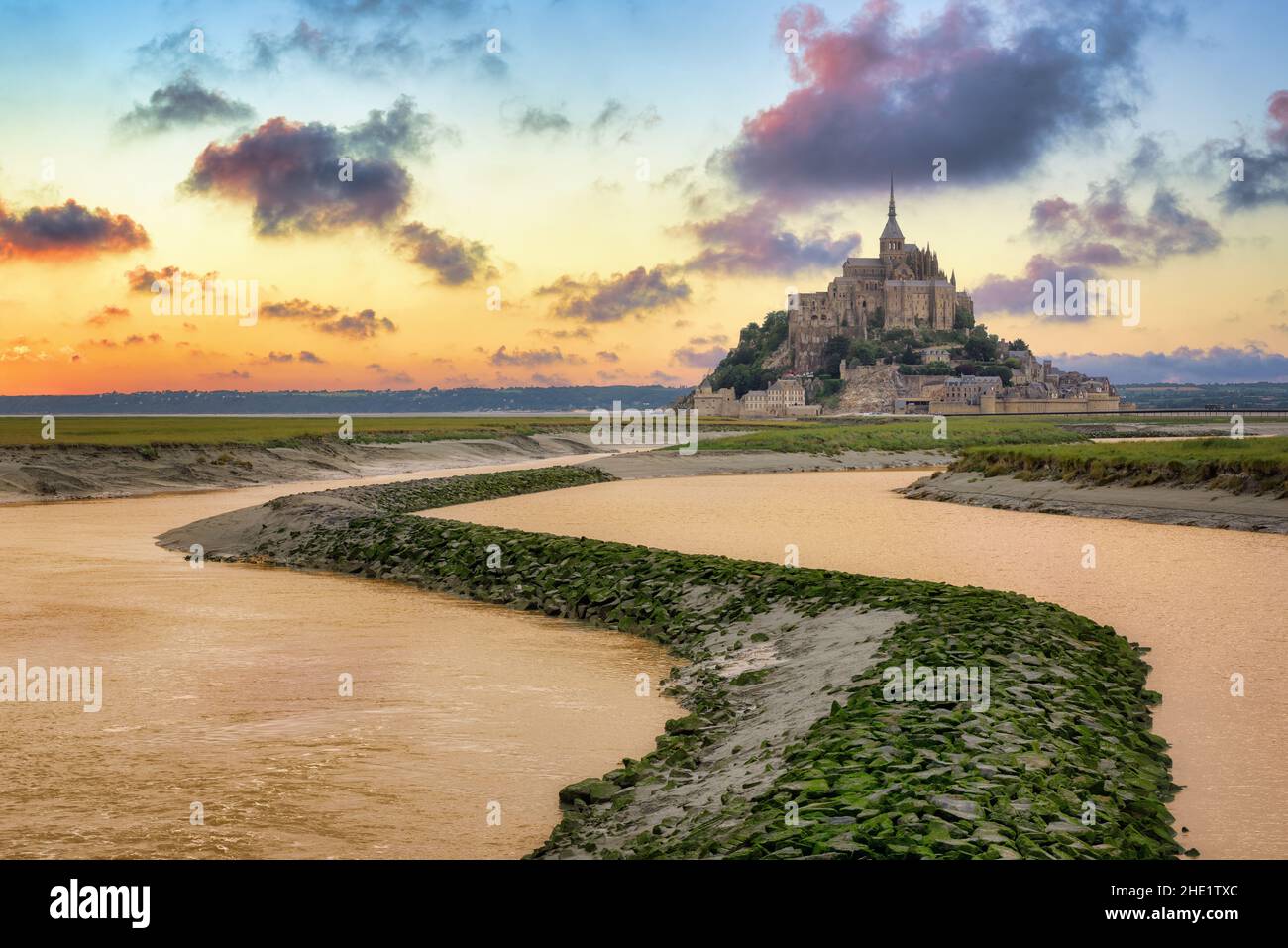 Le Mont Saint Michel island, Normandy, in dramatic sunset light. Mont Saint-Michel is one of the most popular tourist destinations in France Stock Photo