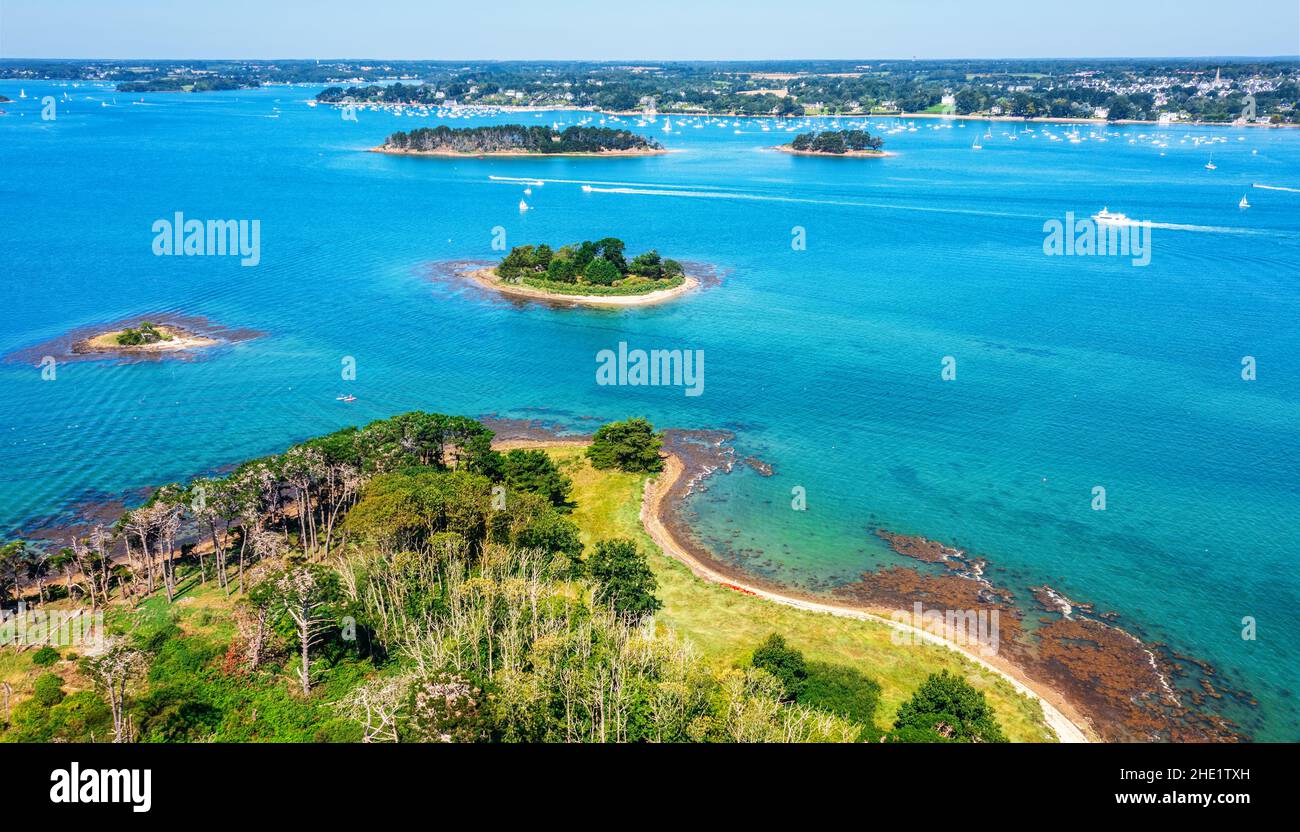 Small islands scattered in the blue water of the Gulf of Morbihan on atlantic coas of Brittany, France Stock Photo