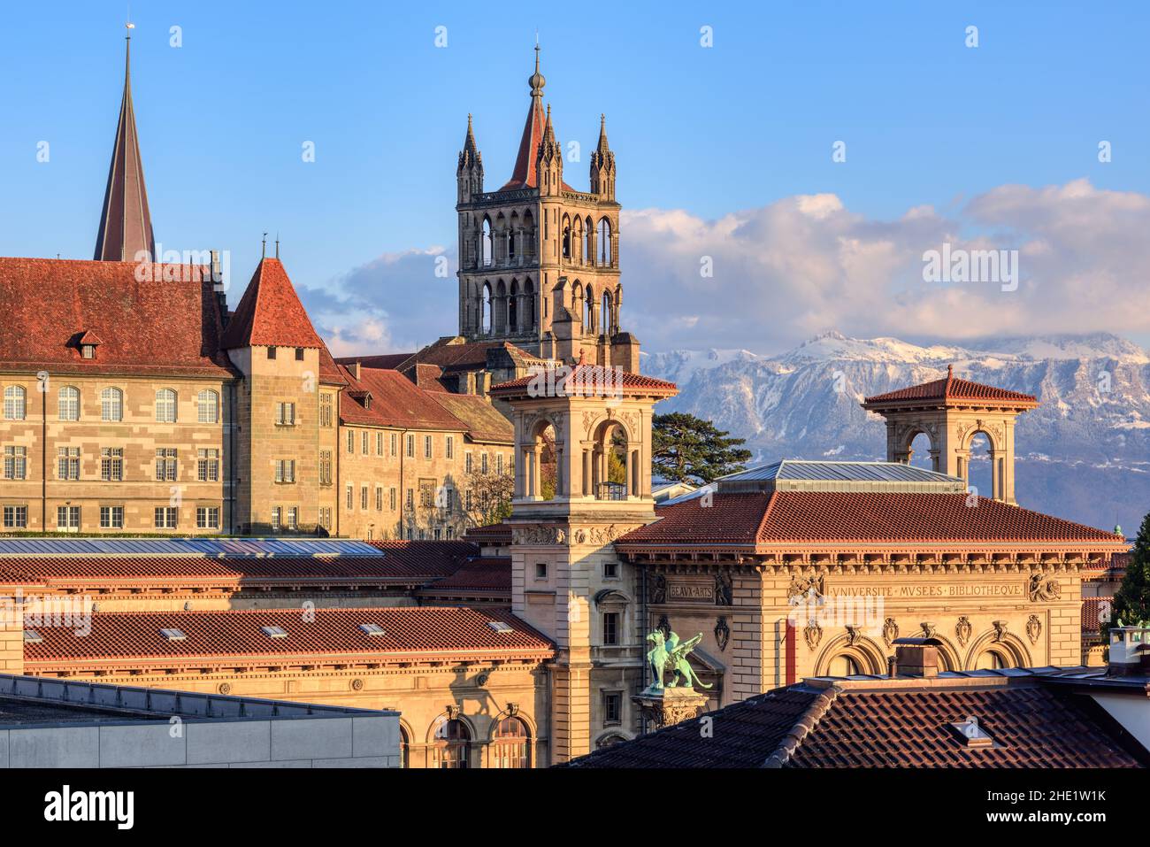 Lausanne city, view of the gothic Cathedral, Rumine palace museum (with inscripts Arts, University, Museum, Library) and the snow covered Alps mountai Stock Photo