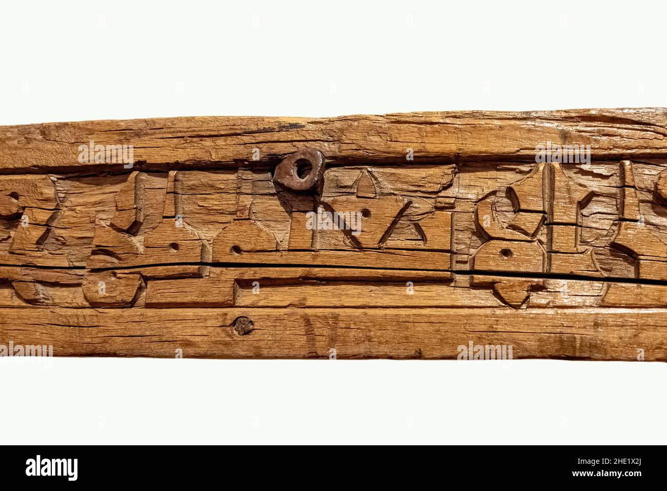 Close up of 9th century wooden frieze or beam carved with motifs and Quranic inscriptions. The Aga Khan Museum is a museum of Islamic art, Iranian art Stock Photo
