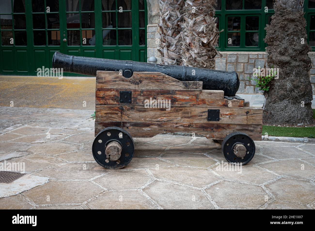 Old defense cannon. The barrel support is made of wood with wheels Stock Photo