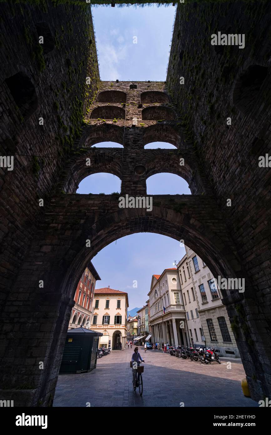 Porta Torre, Tower Gate, located at Piazza Vittoria, was completed in 1192 and has a hight of 40 meters. A woman is cycling through. Stock Photo