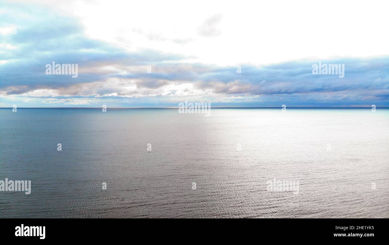 Aerial image looking out to sea looking over Cardigam Bay.  Cloudy but bright showing light on the sea Stock Photo