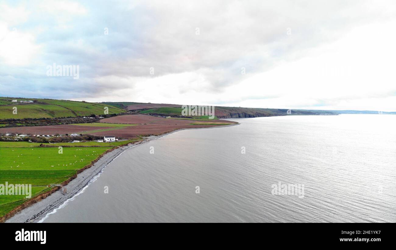 Aerial image overlooking Llanon coast showing the sea, coastal path, fields and beach Stock Photo