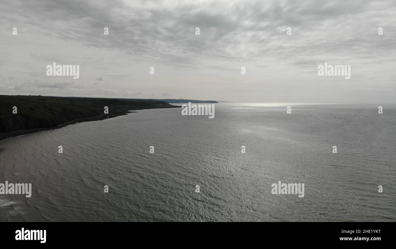 Aerial image overlooking Llanon coast showing the sea, coastal path, fields and beach Stock Photo