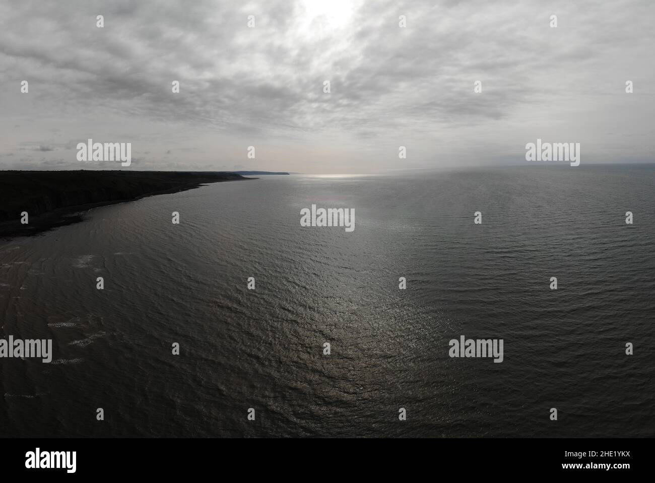 Aerial image overlooking Llanon coast showing the sea, coastal path, fields and beach Stock Photo