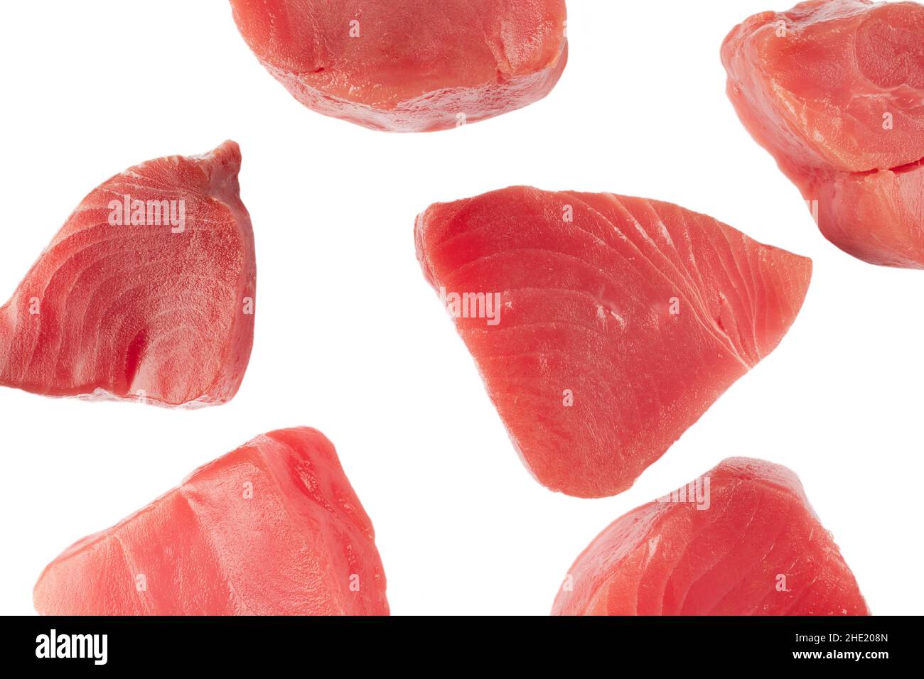 Yellow fin tuna steaks isolated on black background. Fresh rare tuna steaks isolated on black
