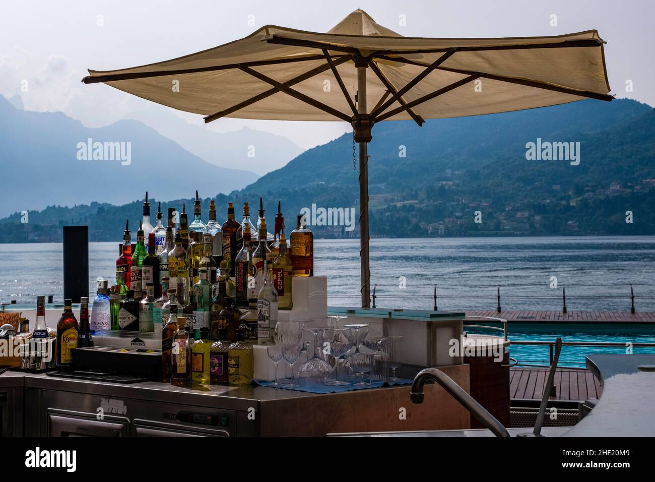 Minibar with bottles of alcoholic drinks and parasol at the lakeside of Grand Hotel Tremezzo. Stock Photo