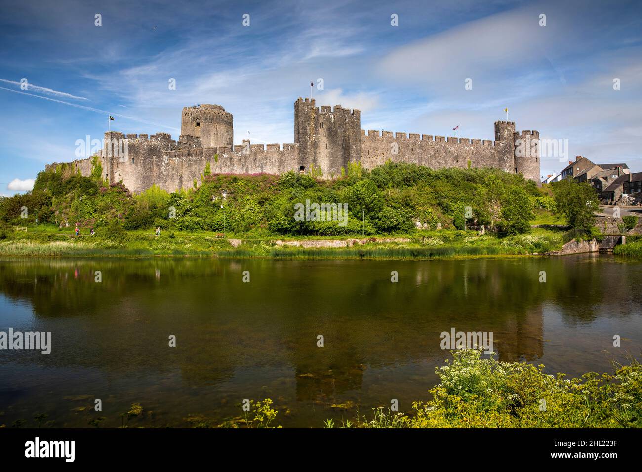 UK, Wales, Pembrokeshire, Pembroke, Castle across Mill Pond Stock Photo