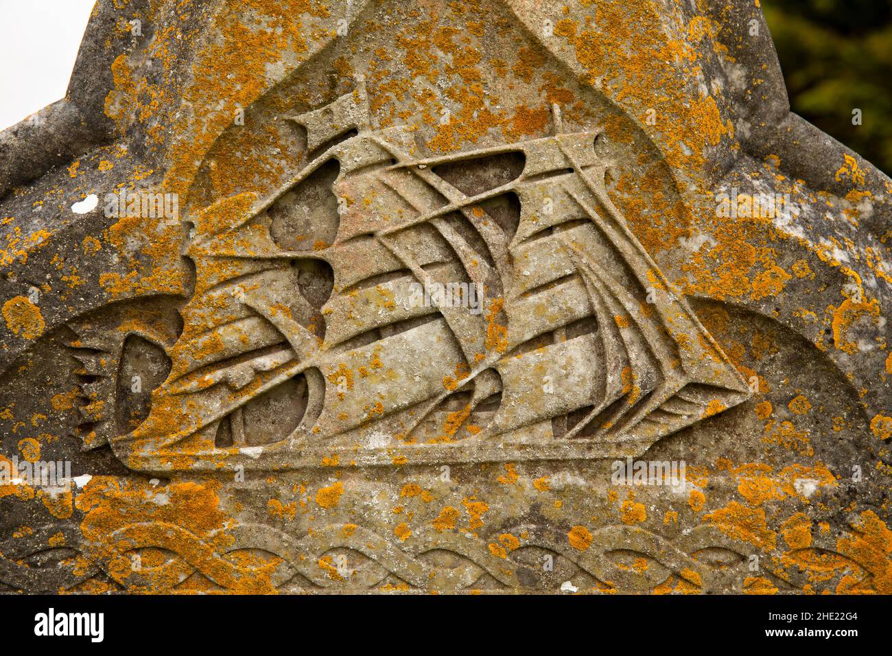 UK, Wales, Pembrokeshire, Angle, St Mary’s churchyard, Thomas Jones’ lichen-covered 1899 sailing ship motif gravestone Stock Photo