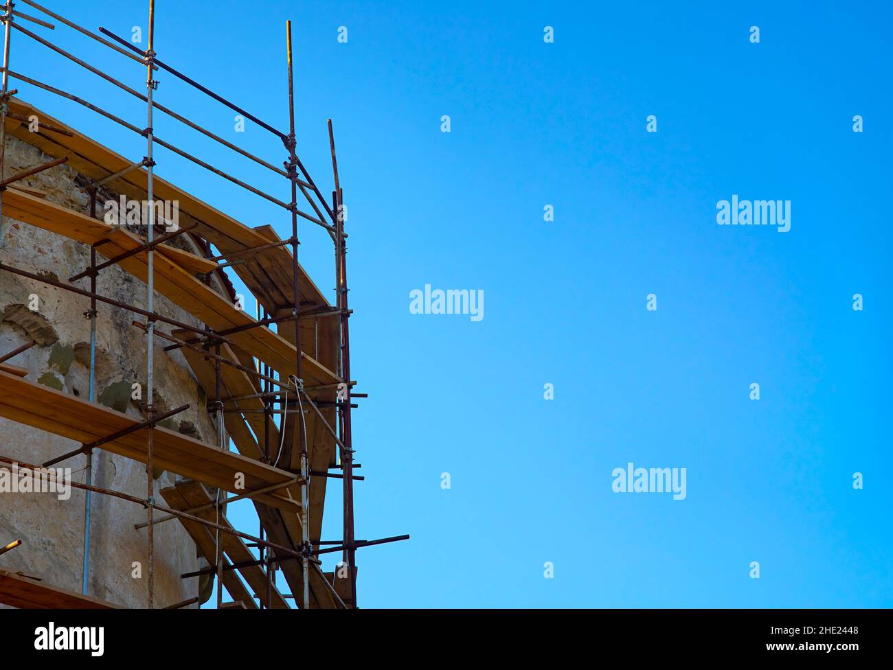 Restoration of an old building top with scaffold around. Stock Photo