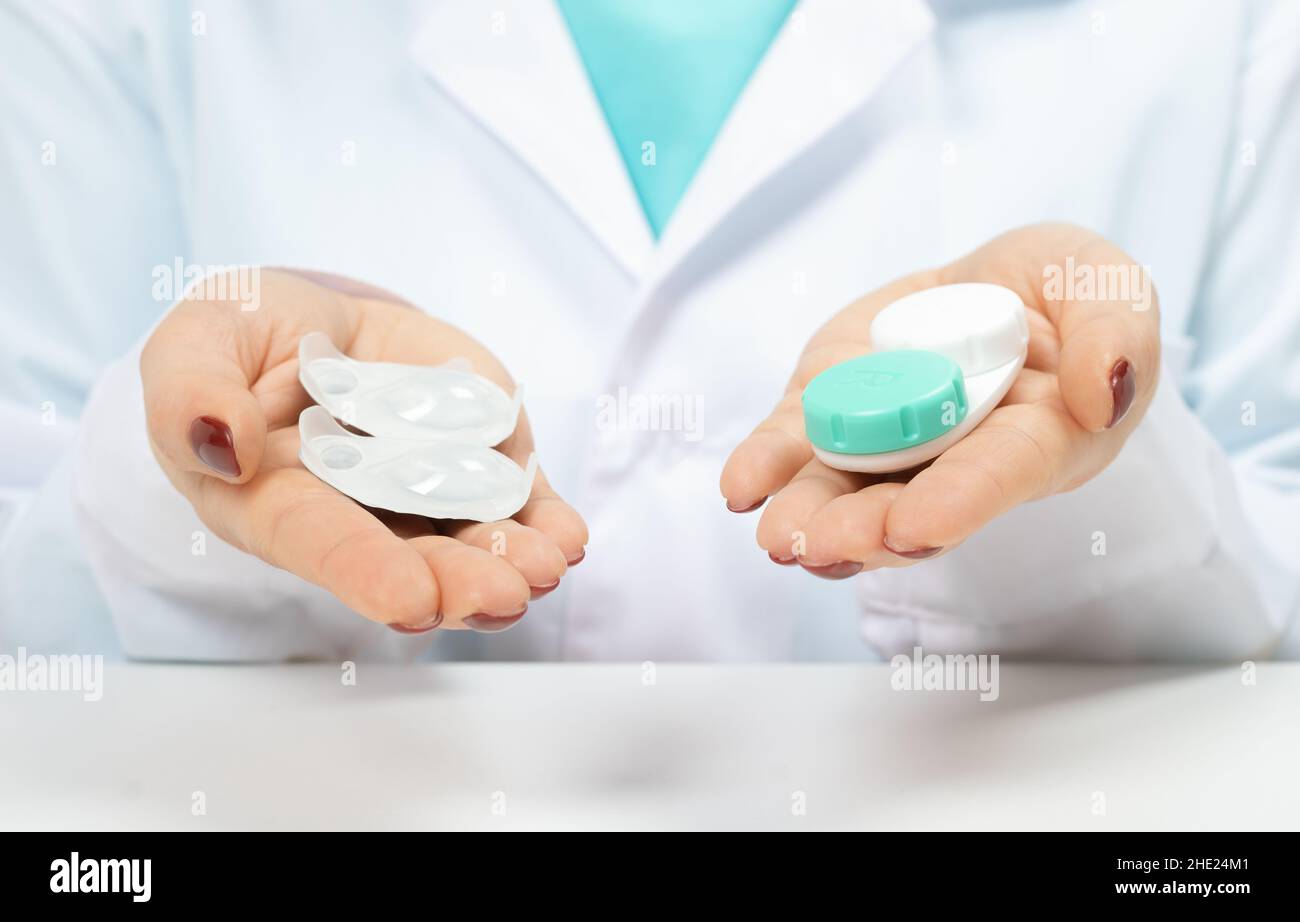 Doctor Ophthalmologist holding in hands oneday contact lenses and reusable contact lenses