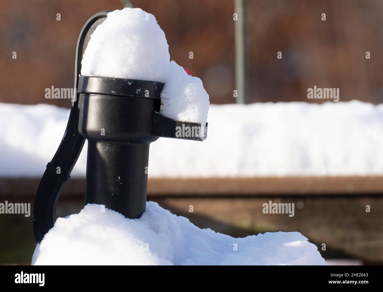 A water pump covered in snow Stock Photo