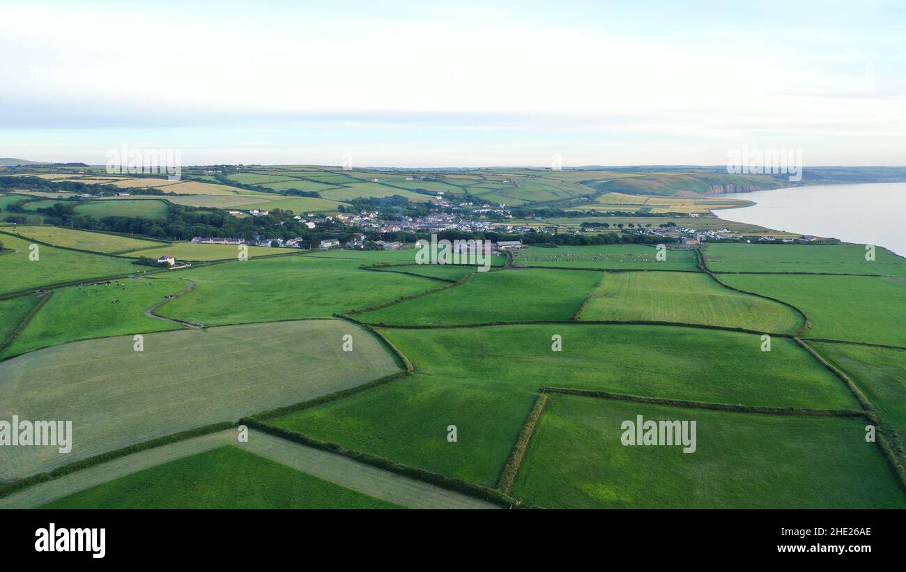 Aerial image looking over fields to the village of Llanon, showing the beach, fields and sea with further views. Stock Photo