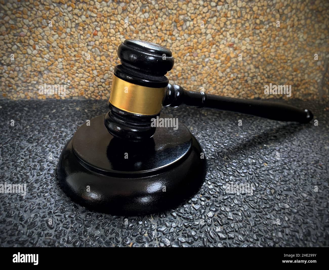 Close up of judge gavel on black and brown marble background. Law concept. Stock Photo