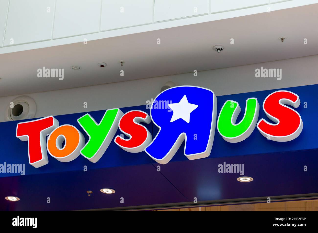 Closeup of Toys R Us brand logo in the front of a large toy store in