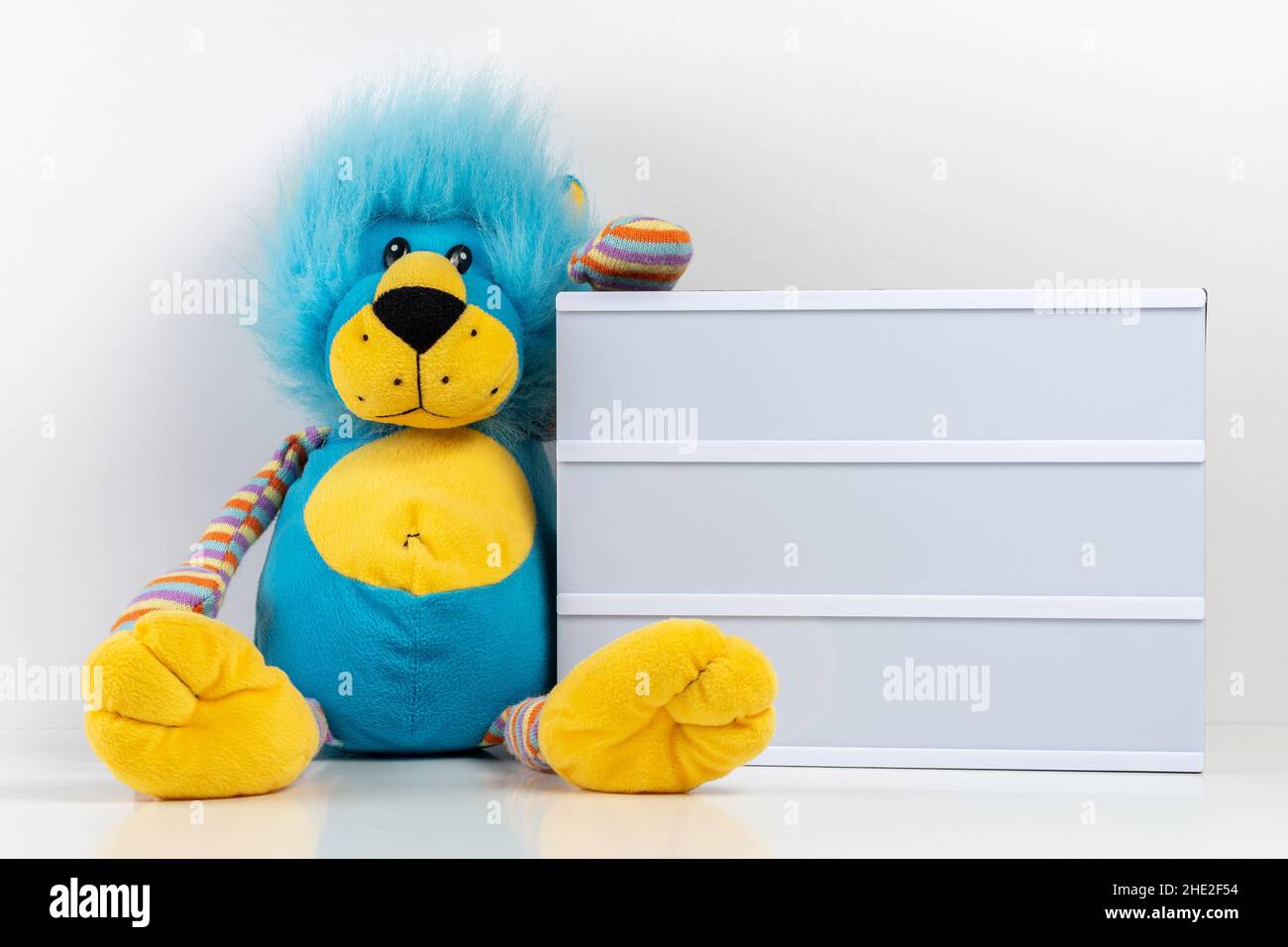 Empty lightbox with lion toy on white table. Mockup concept. Stock Photo