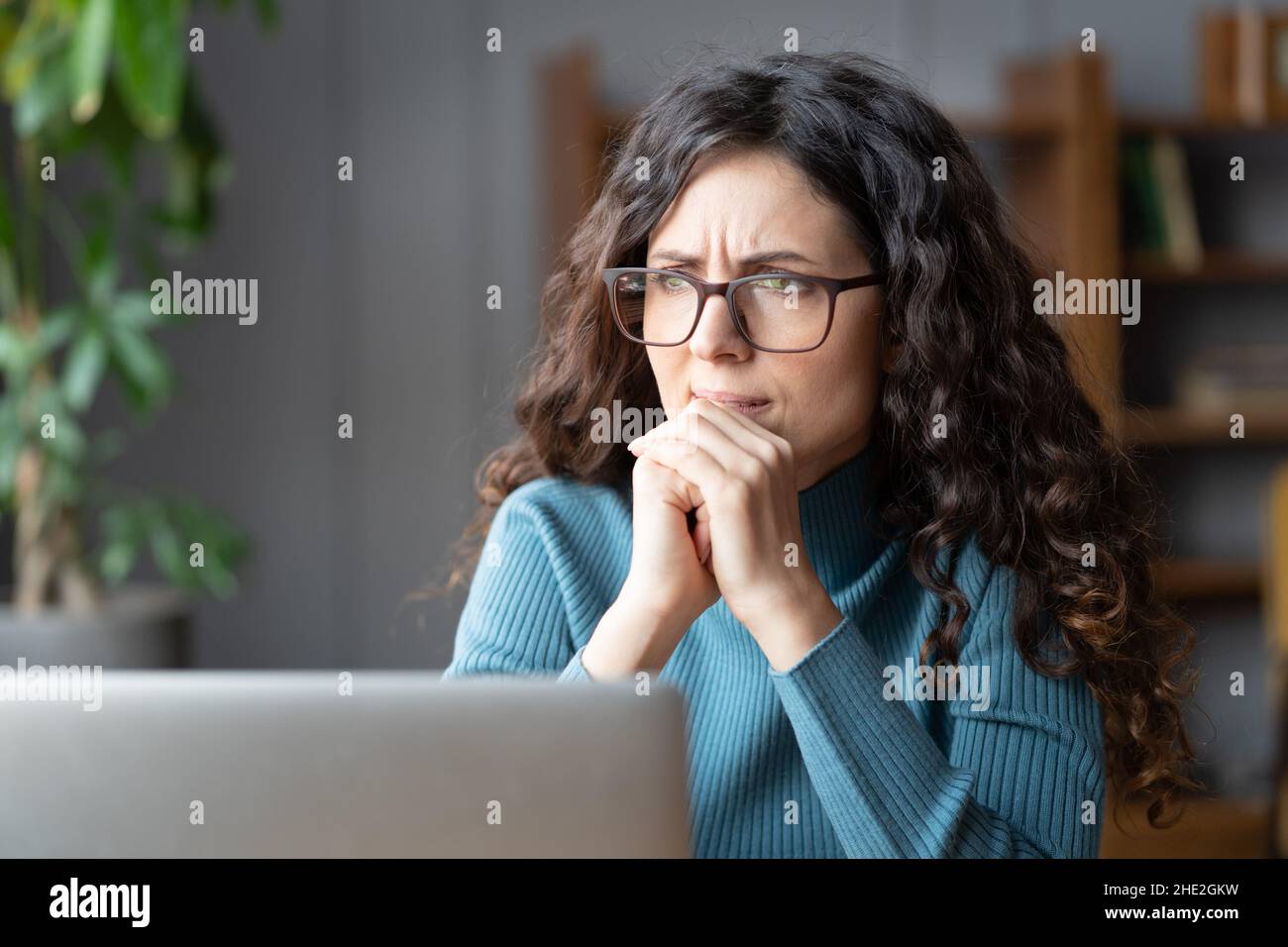 Frustrated woman at laptop think about bad news, solution for problem at work, mistake or deadline Stock Photo
