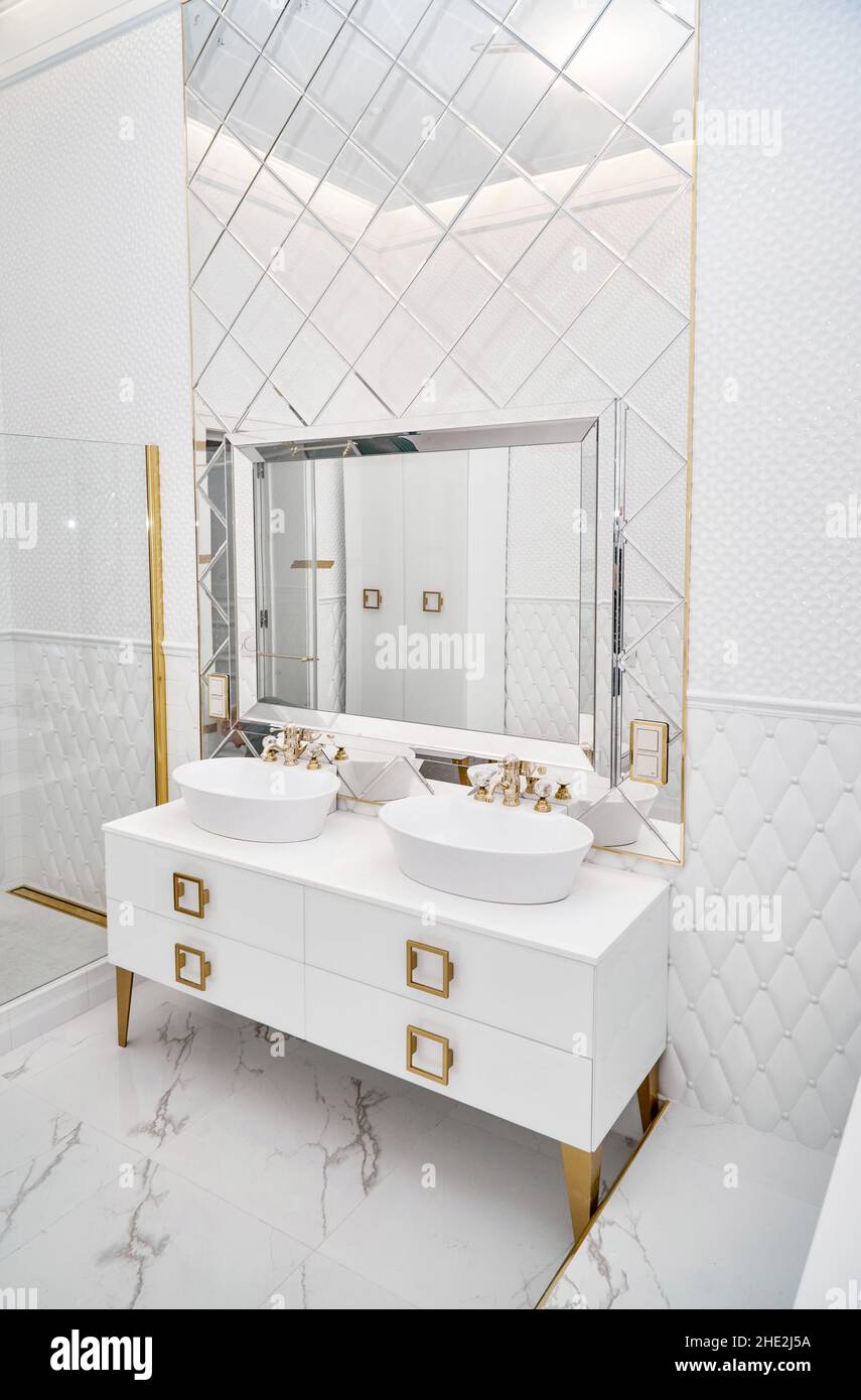 White with golden handles and legs with elegant vessel sinks by