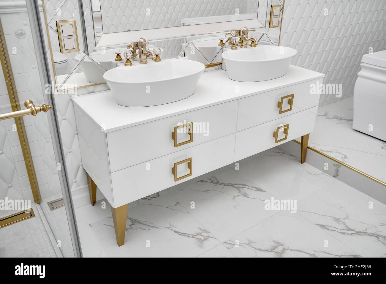 White with golden handles and legs with elegant vessel sinks by