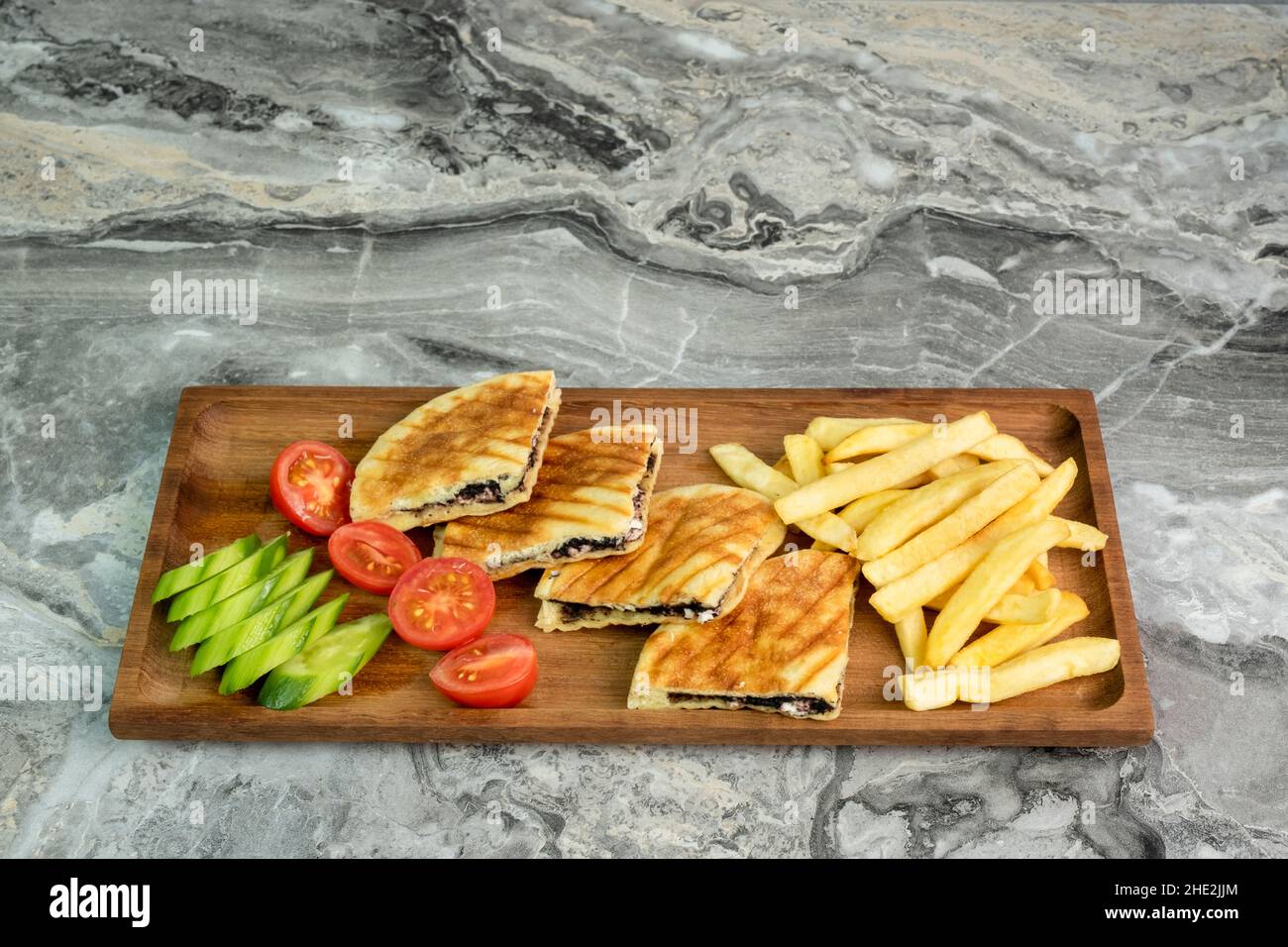 toast in wooden serving platter on marble background Stock Photo
