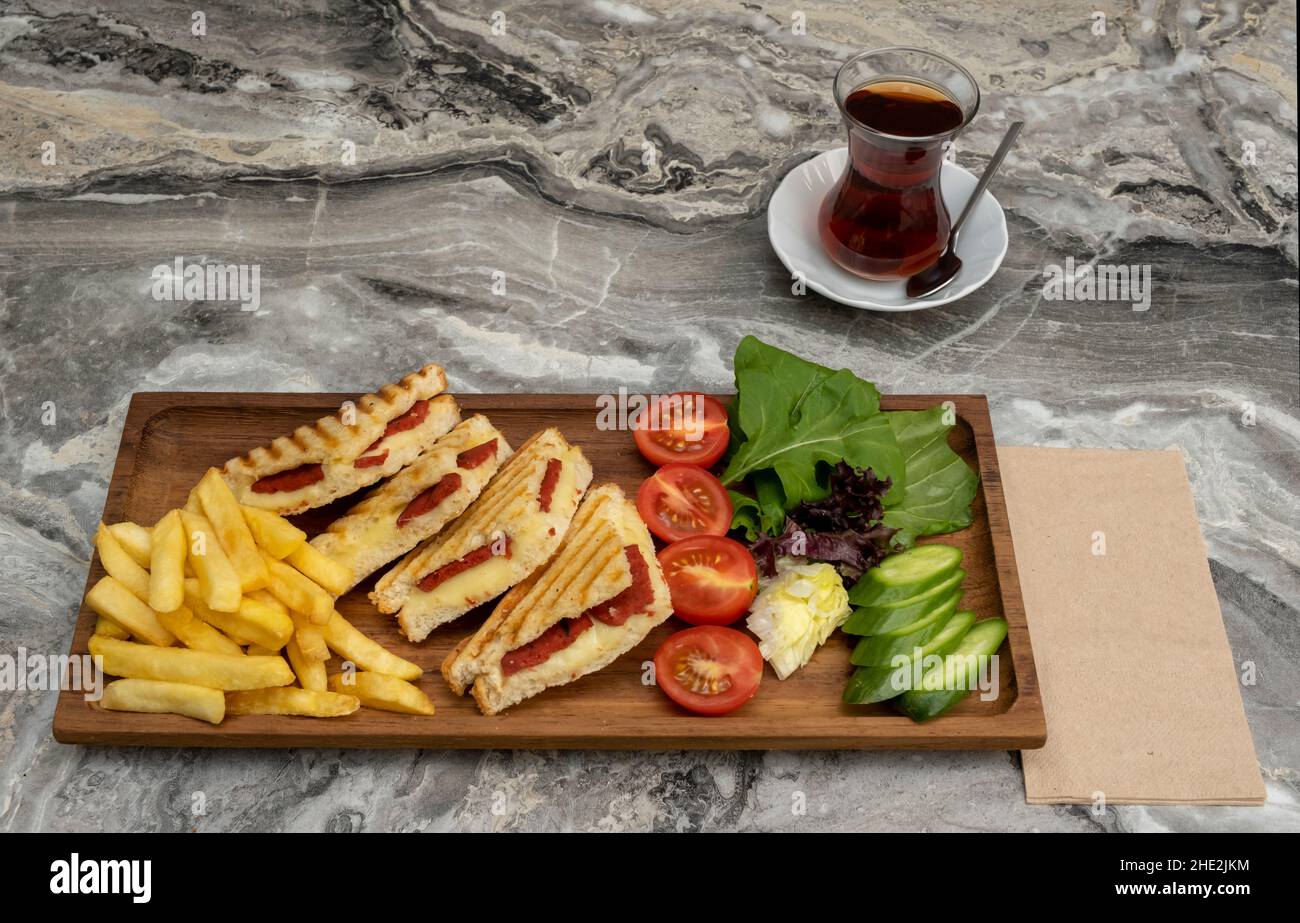 toast in wooden serving platter on marble background Stock Photo
