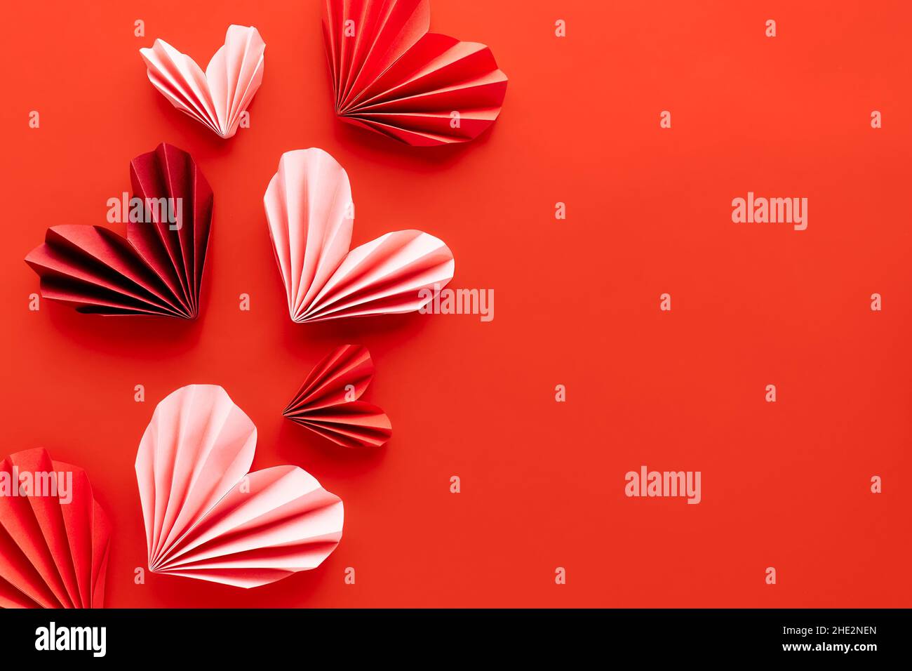 Paper hearts on red background. Symbol of love for valentines day ...