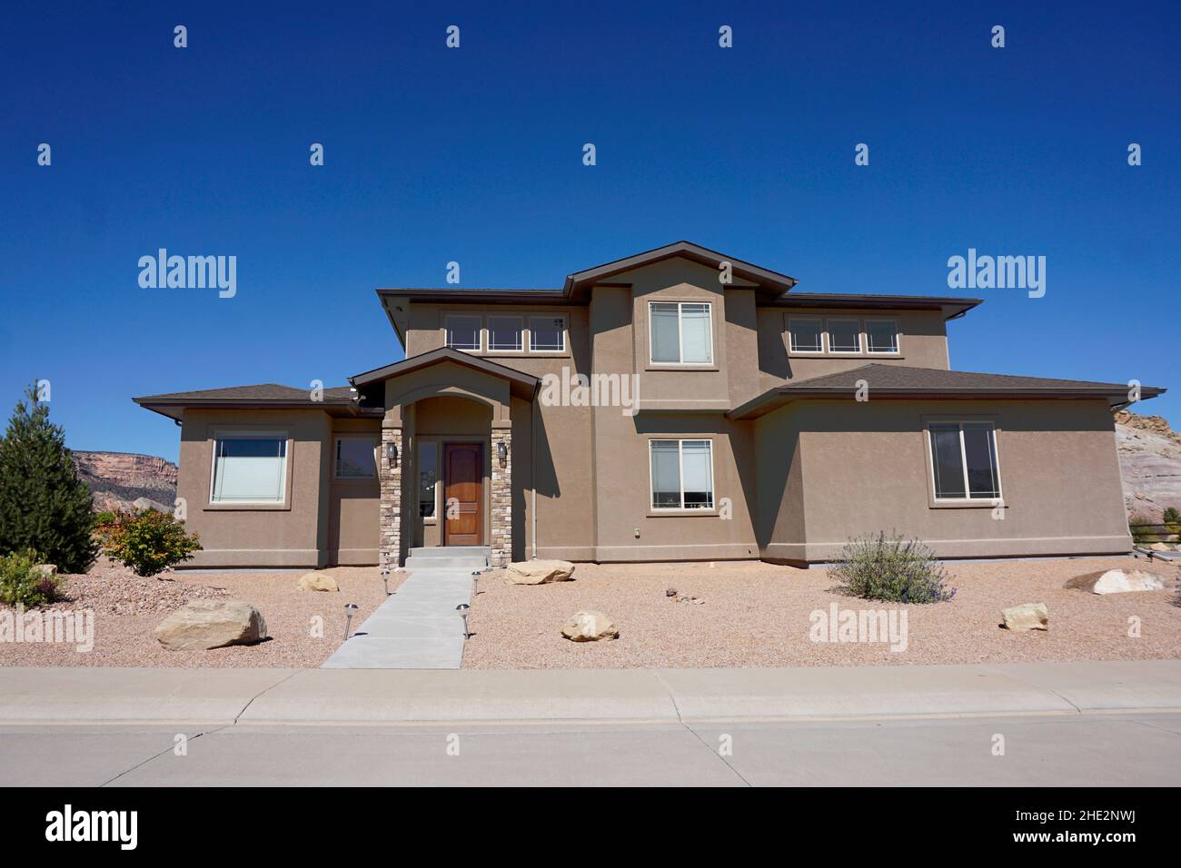 Suburban house in a neighborhood in Colroado. The landscaping is designed for arid areas and uses no irrigation, sometimes referred to as xeriscape la Stock Photo